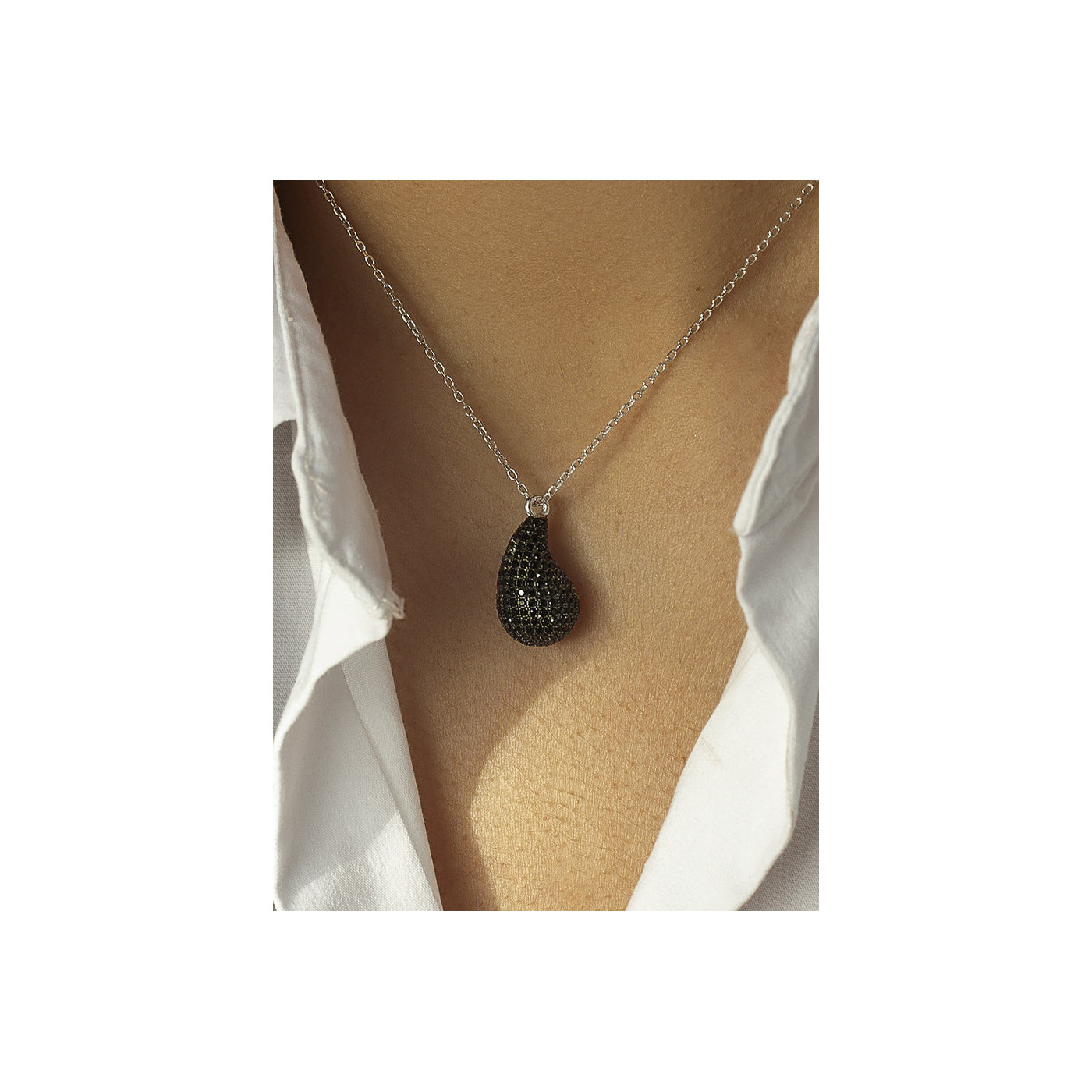 Silver necklace with a black teardrop pendant
